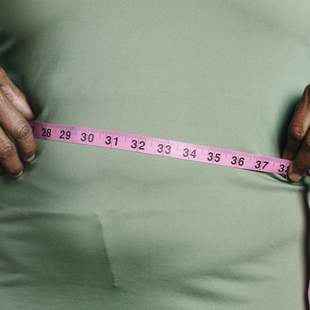 woman measuring her belly