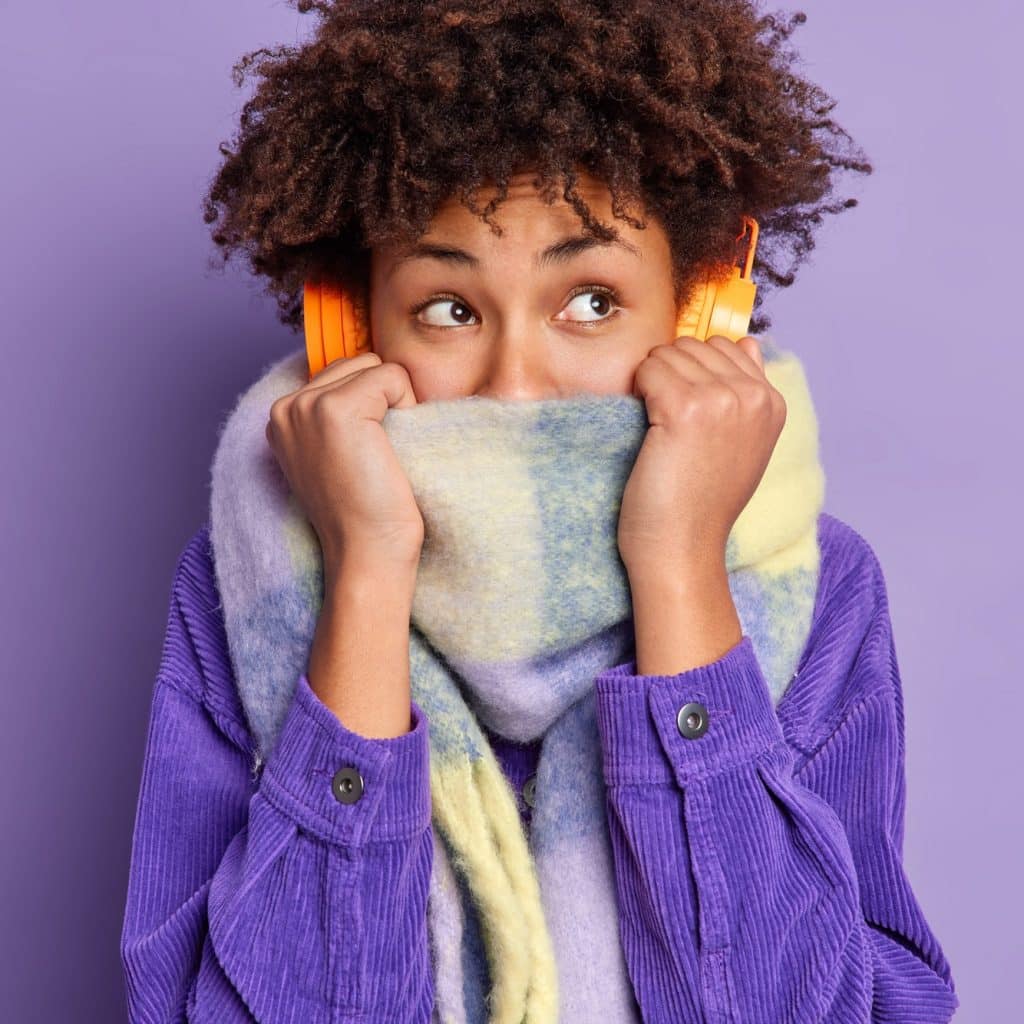 Chilly woman face buried in her scarf